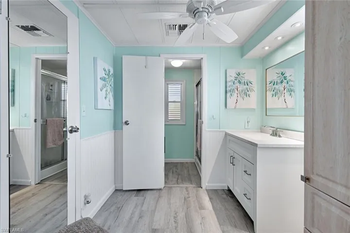 Updated primary bathroom with oversized vanity, modern finishes, and ample storage.