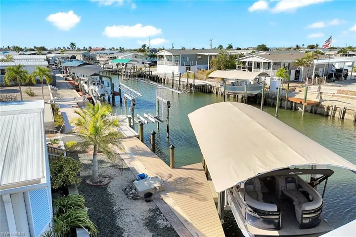 Aerial perspective highlighting the surrounding waterfront neighborhood and canal system.