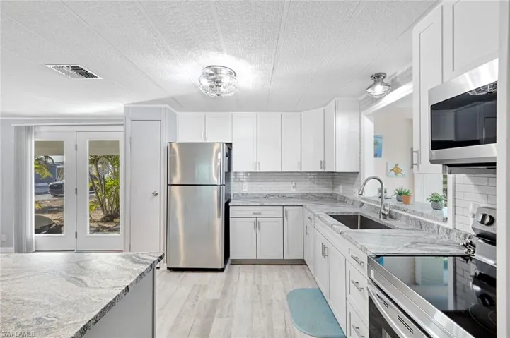 Modern kitchen with quartz countertops, stainless steel appliances, soft-close cabinetry, and generous prep space.