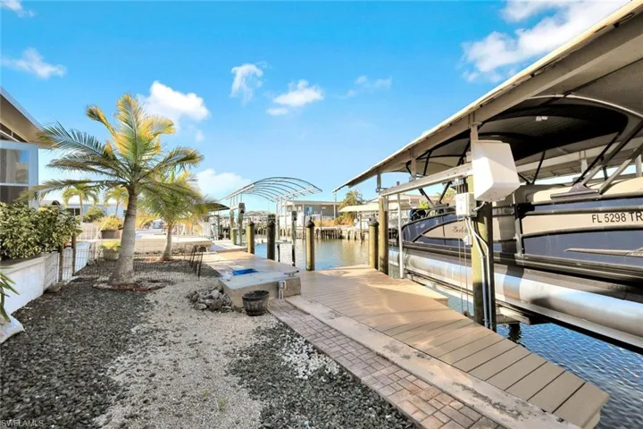Private waterfront dock with covered boat lift and direct access to Pine Island Sound and the Gulf of Mexico.