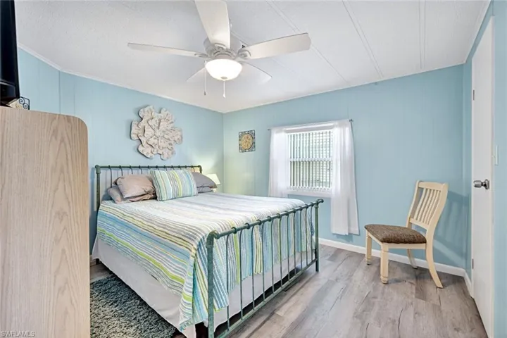 Comfortable guest bedroom with coastal colors, generous closet space, and abundant natural light.