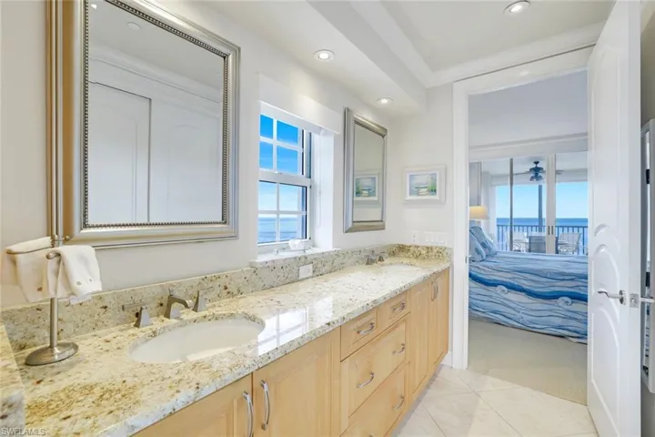 Full bathroom with ensuite bathroom, double vanity, recessed lighting, and tile patterned flooring