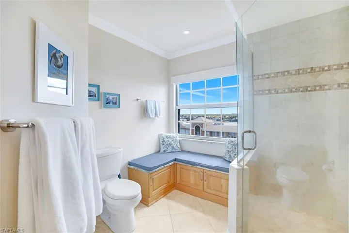 Full bathroom with crown molding, tile patterned flooring, and a stall shower