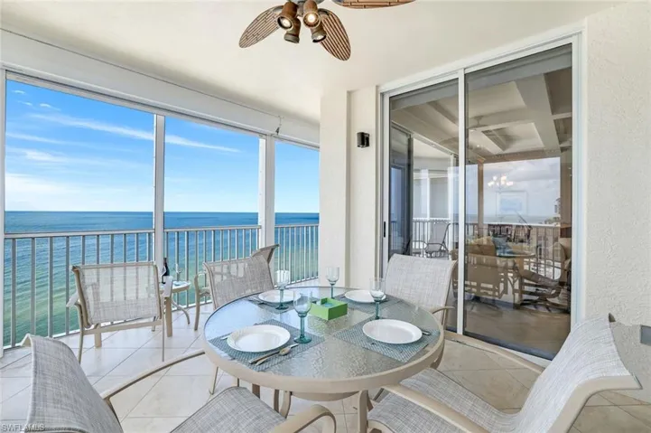 Sunroom with a water view and tile patterned floors