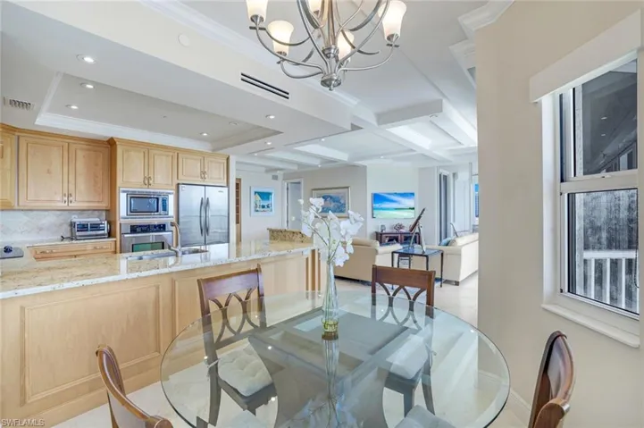 Dining room featuring coffered ceiling, a chandelier, beam ceiling, ornamental molding, and recessed lighting