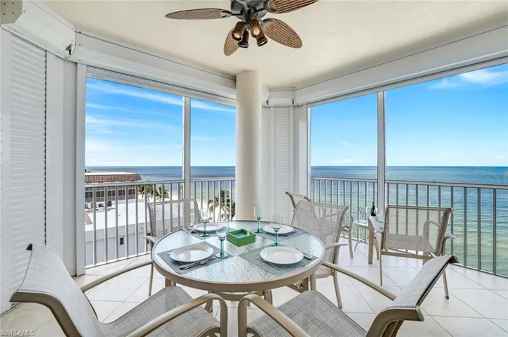 Sunroom with a water view, tile patterned flooring, and healthy amount of natural light