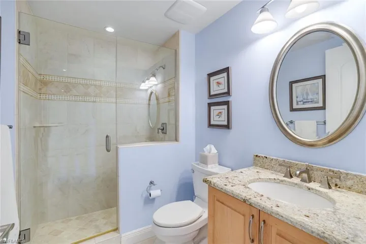 Bathroom with vanity and a stall shower