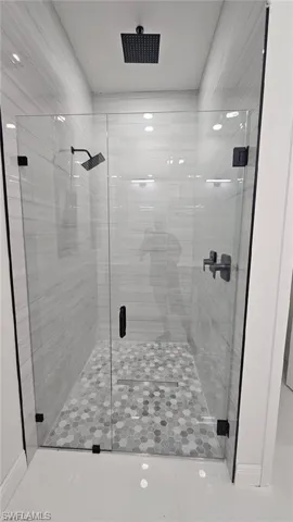 Bathroom featuring an enclosed shower and tile patterned floors