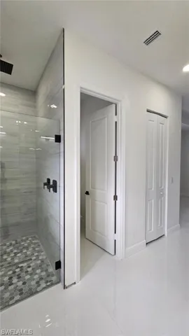 Bathroom featuring a shower with door