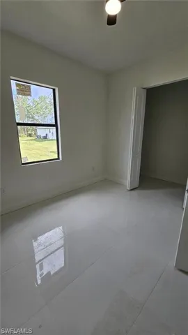 Empty room with light tile patterned floors