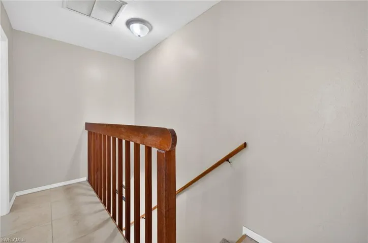 Staircase featuring wood railings and a wood handrail
