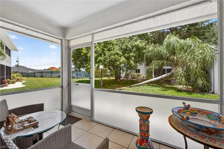 Screened patio featuring tile flooring and an outdoor ceiling fan