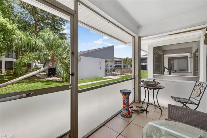 Screened patio featuring tile flooring and a textured ceiling