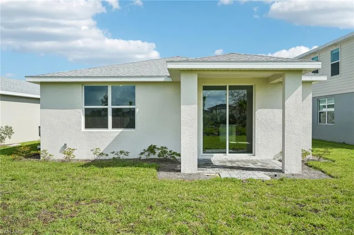 Rear view of house with a lawn