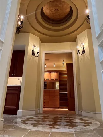 Primary Suite Hall Between Bathroom and Closet with Wet Bar to left.