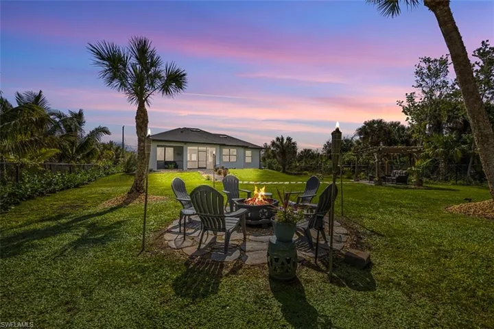 Yard at dusk with an outdoor fire pit