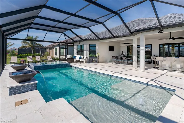 View of pool featuring ceiling fan, an outdoor living space, a patio, and a pool with connected hot tub