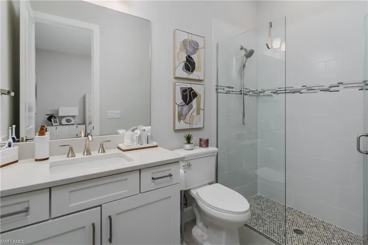 Bathroom featuring a shower stall and vanity