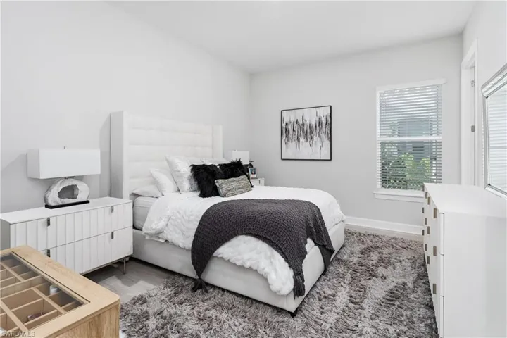 Bedroom featuring baseboards and wood finished floors