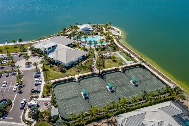 Aerial view of a pool area and a large body of water