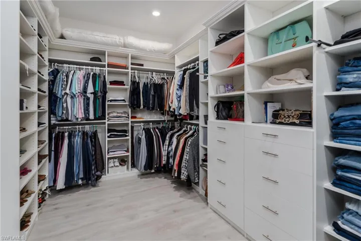 Spacious closet with light wood-style floors