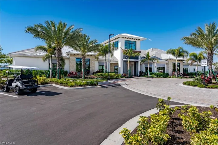 View of building exterior featuring uncovered parking