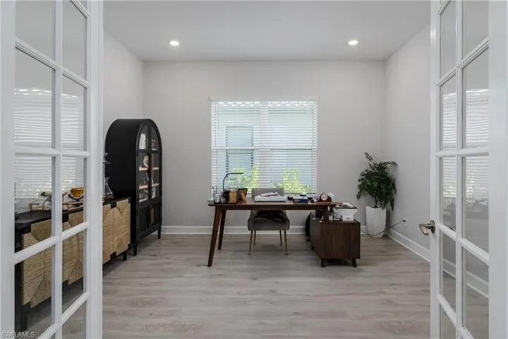 Office area featuring french doors, light wood-style floors, and recessed lighting