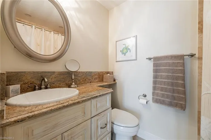 Full bathroom featuring curtained shower and vanity