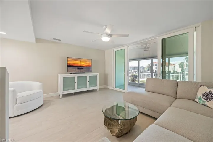 Living Room with tile floors, impact resistant doors and water views