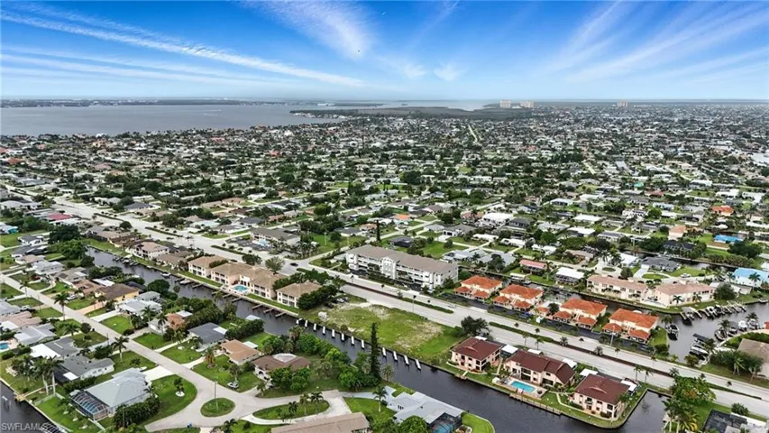 Aerial overview of property's location with a nearby body of water and nearby suburban area