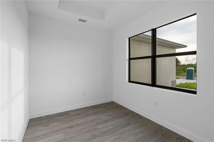 Spare room with hardwood / wood-style flooring