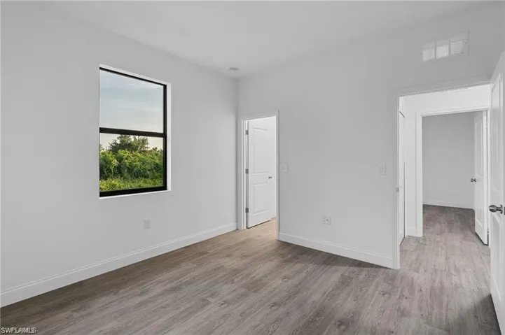 Empty room featuring wood-type flooring