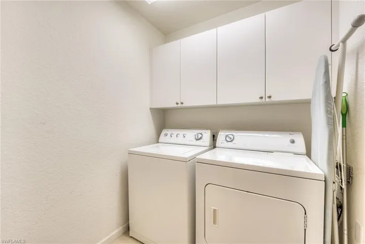 Laundry room next to garage entrance
