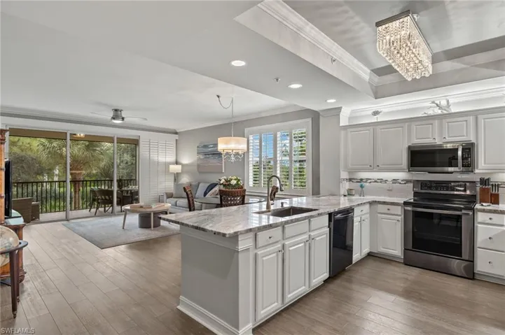 Sensational kitchen with granite counters, stainless steel appliances, backsplash and custom lighting.