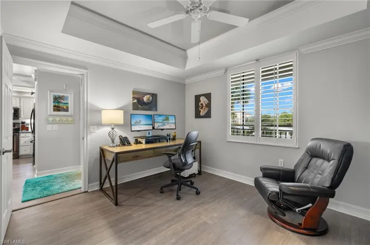 Guest bedroom also offers a tray ceiling and ceiling fan.
