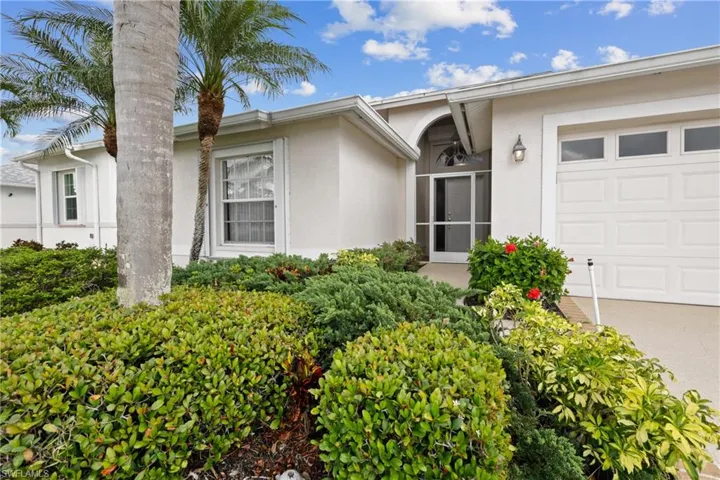 View of exterior entry with stucco siding and an attached garage