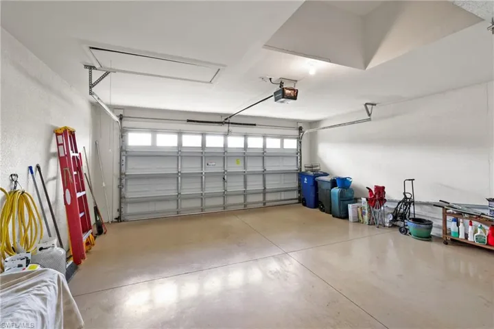 Garage featuring a garage door opener