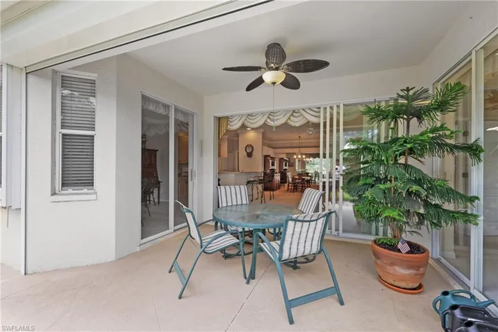 Sunroom with ceiling fan and outdoor dining space