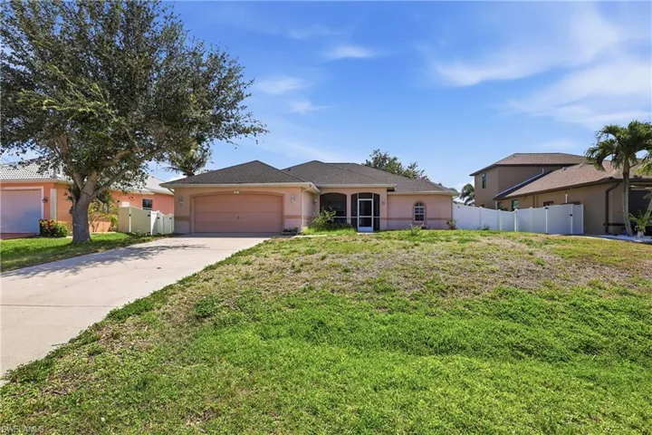 2 car garage with walkway to front screened lanai.