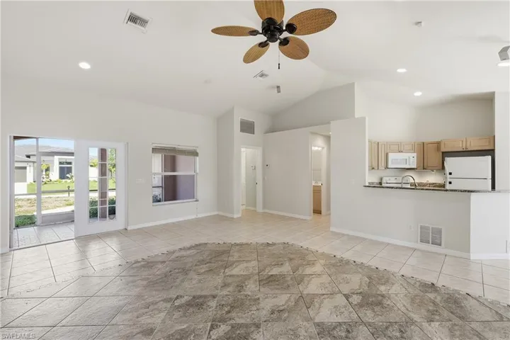 Great room open to the kitchen with half guest bath to the left.