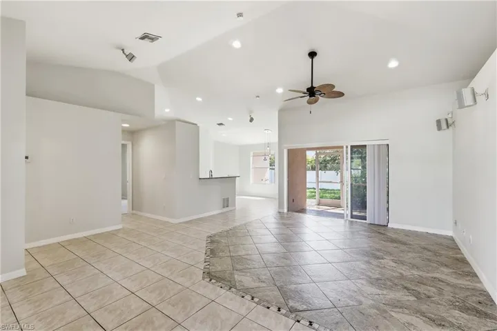 Great room, to rear screened lanai. Primary suite is to the right.