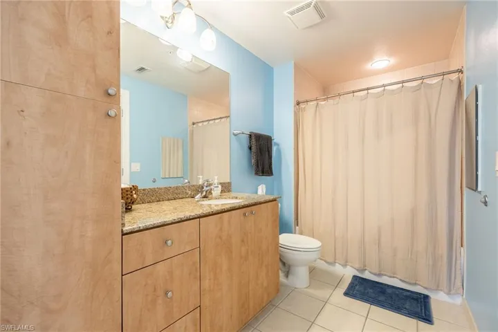 Full bath featuring vanity and light tile patterned floors