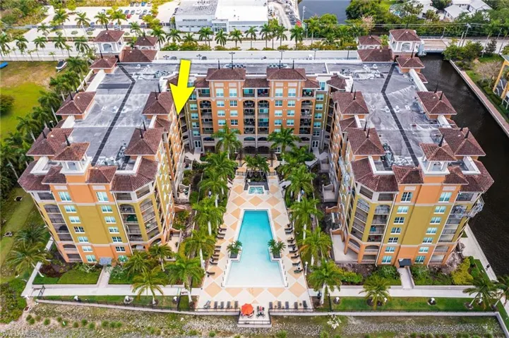 Drone / aerial view of apartment complex and a nearby body of water