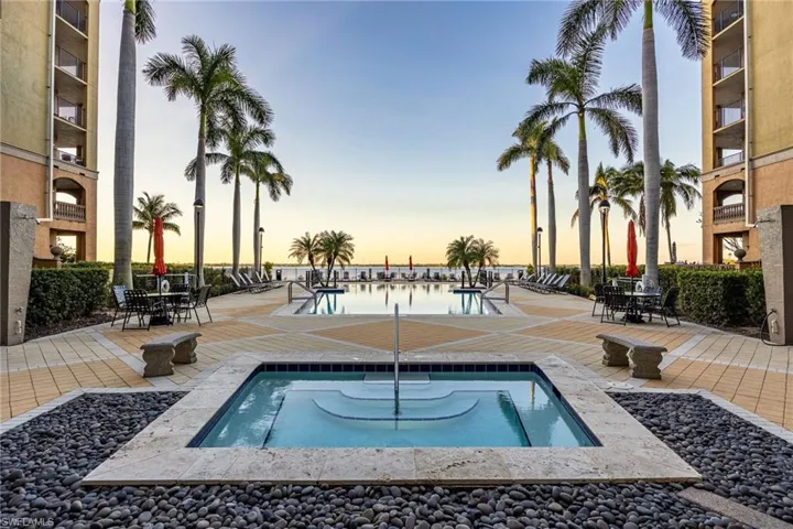Community pool with a patio and a hot tub