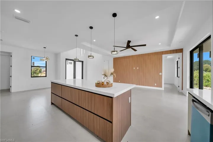 Kitchen island featuring wood-finish cabinetry and a light-toned countertop