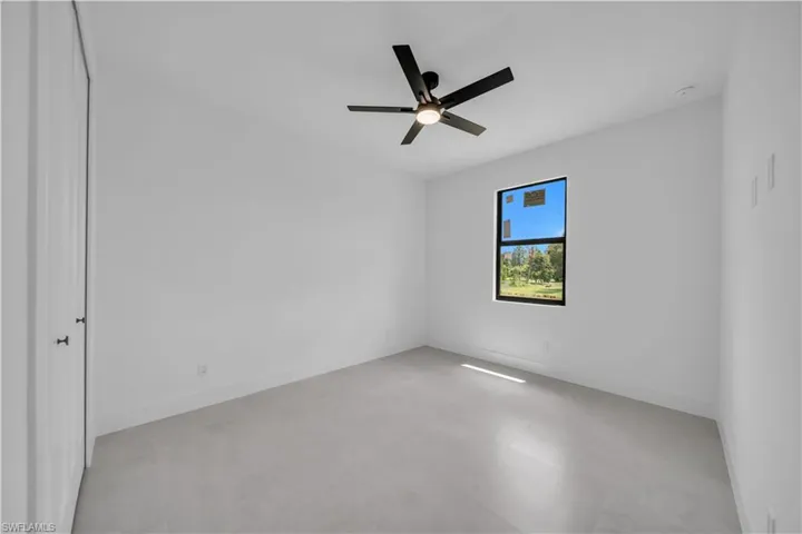 Bright room featuring light-toned flooring and white walls