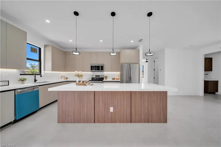 Contemporary kitchen featuring a large island with wood-finish paneling and a light-toned countertop