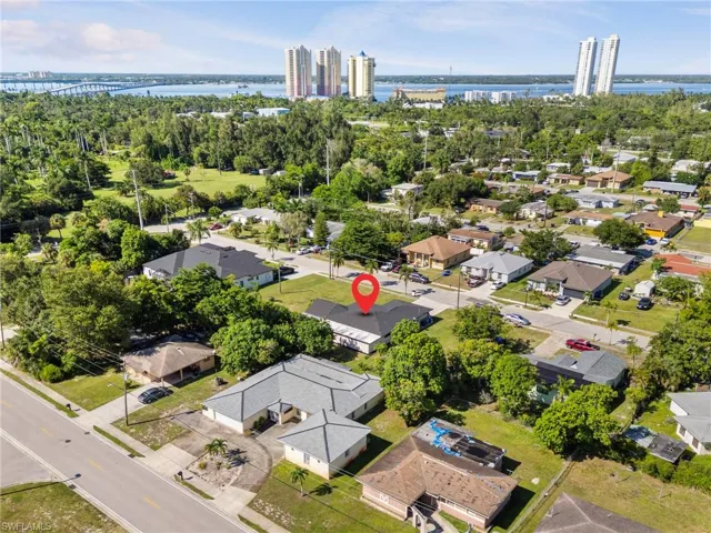Aerial view of residential area featuring a nearby body of water and a notable bridge