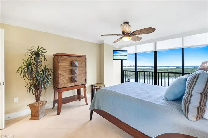 Tiled bedroom with floor to ceiling windows, crown molding, access to exterior, and ceiling fan