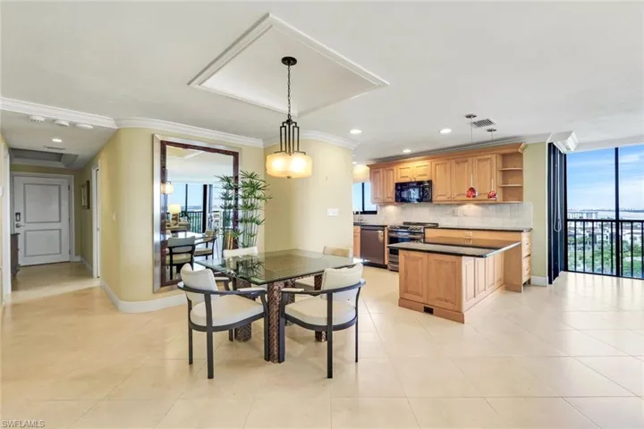 Dining space with recessed lighting, light tile patterned floors, and ornamental molding